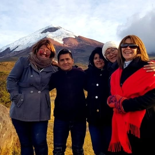 Travelers visiting the Cotopaxi highlands near the volcano.